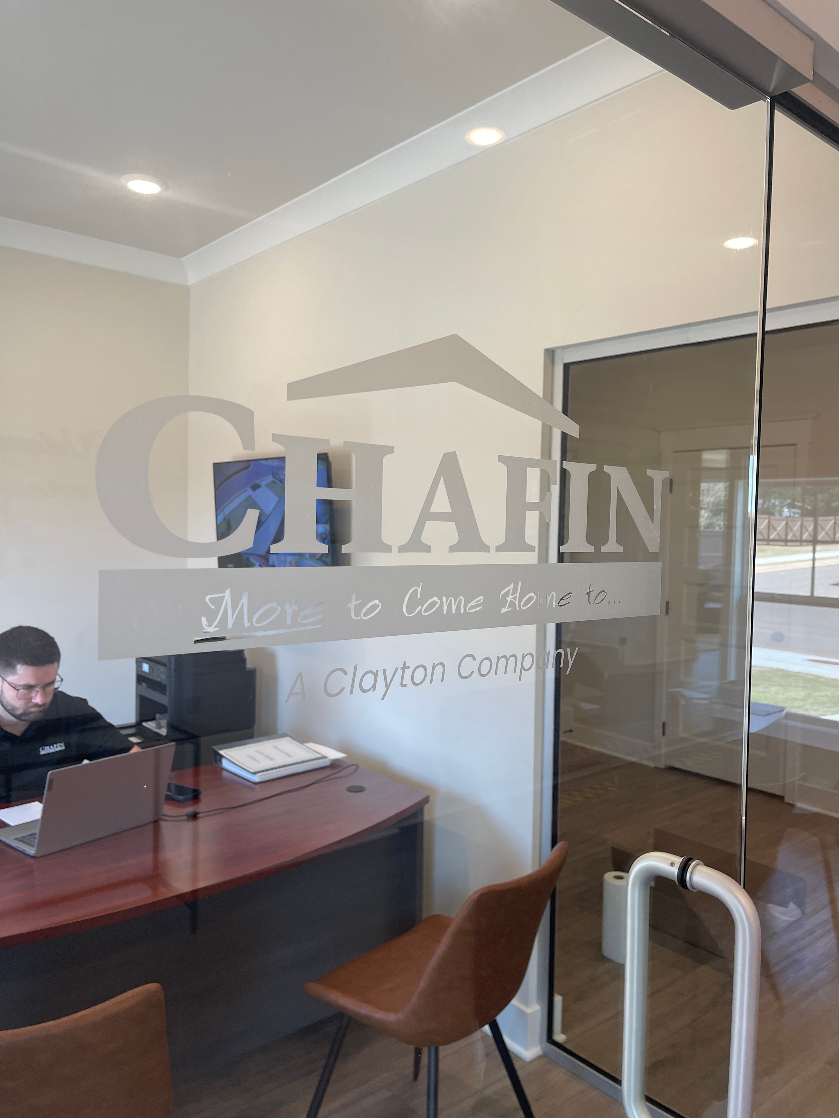Chafin A Clayton Company brushed metal dimensional wall logo with tagline More to Come Home To